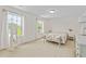 Bright bedroom with plush carpeting, light walls, large windows, and sitting bench at the end of the bed at 817 Stable Fern Dr, Fuquay Varina, NC 27526