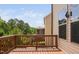 Elevated wooden deck with brown railings offers backyard view, complemented by neutral siding at 817 Stable Fern Dr, Fuquay Varina, NC 27526