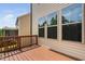 Wooden deck with brown railing and windows offers outdoor relaxation with a view at 817 Stable Fern Dr, Fuquay Varina, NC 27526