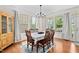 Inviting dining room with hardwood floors, large windows, and a chandelier for elegant meals at 817 Stable Fern Dr, Fuquay Varina, NC 27526