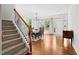 Bright dining room showcasing hardwood floors, staircase, and natural light, perfect for Gathering meals at 817 Stable Fern Dr, Fuquay Varina, NC 27526