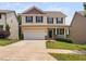 Charming two-story home with a well-manicured lawn, attached two-car garage, and inviting front porch at 817 Stable Fern Dr, Fuquay Varina, NC 27526