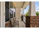 Charming front porch with brick columns, neutral chairs, and view of the neighborhood offering a relaxing outdoor space at 817 Stable Fern Dr, Fuquay Varina, NC 27526