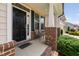 The front porch welcomes visitors with chairs, brick columns, and a charming black door, offering curb appeal at 817 Stable Fern Dr, Fuquay Varina, NC 27526