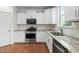 Well-lit kitchen with granite countertops, stainless steel appliances, white cabinetry, and a subway tile backsplash at 817 Stable Fern Dr, Fuquay Varina, NC 27526