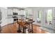 Bright kitchen with stainless appliances, island seating, white cabinets, and glass doors leading to an outdoor space at 817 Stable Fern Dr, Fuquay Varina, NC 27526
