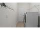 Functional laundry room with modern washer and dryer, shelving, and ample storage space at 817 Stable Fern Dr, Fuquay Varina, NC 27526