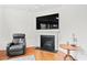 Cozy living room with a fireplace and mounted television for entertainment and relaxation at 817 Stable Fern Dr, Fuquay Varina, NC 27526