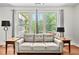 Comfortable living room with a plush sofa, side tables, and large windows providing ample natural light at 817 Stable Fern Dr, Fuquay Varina, NC 27526