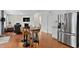 Open concept living space with a kitchen, dining table, living area and stainless steel appliances at 817 Stable Fern Dr, Fuquay Varina, NC 27526