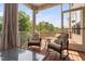 Screened porch with cozy seating and a view of the surrounding trees at 817 Stable Fern Dr, Fuquay Varina, NC 27526