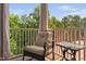 Relaxing screened porch features cushioned rocking chair, table, and tree-lined view at 817 Stable Fern Dr, Fuquay Varina, NC 27526