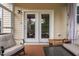 Inviting outdoor living space with comfortable seating and convenient access to indoors through doors at 817 Stable Fern Dr, Fuquay Varina, NC 27526