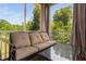 Comfortable screened-in porch with cushioned sofa and glass-topped table, perfect for relaxation at 817 Stable Fern Dr, Fuquay Varina, NC 27526
