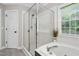 Beautiful bathroom featuring a glass enclosed shower, soaking tub and lots of natural light at 8201 Ivymount Way, Raleigh, NC 27613