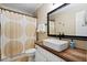 Modern bathroom with a unique above-counter sink and contrasting black hardware at 8201 Ivymount Way, Raleigh, NC 27613