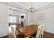 Elegant dining room view into spacious living room with fireplace at 8201 Ivymount Way, Raleigh, NC 27613