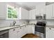 Bright kitchen with white cabinets, granite countertops, and stainless steel appliances at 8201 Ivymount Way, Raleigh, NC 27613