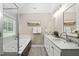 Luxurious main bathroom with double vanity, soaking tub, and glass-enclosed shower at 8201 Ivymount Way, Raleigh, NC 27613