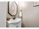 Stylish powder room with elegant mirror and white sink at 8201 Ivymount Way, Raleigh, NC 27613