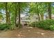 View of the rear exterior featuring lush greenery and well-manicured lawn at 8508 Zinfandel Pl, Raleigh, NC 27615