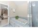 Bathroom featuring a soaking tub with tile surround and a glass shower at 8508 Zinfandel Pl, Raleigh, NC 27615