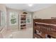 Cozy bedroom featuring a bunk bed, a bookshelf, and natural light from two windows at 8508 Zinfandel Pl, Raleigh, NC 27615