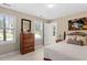 Bedroom with natural light from windows, a wrought iron bed frame, and a wood dresser at 8508 Zinfandel Pl, Raleigh, NC 27615