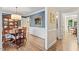 Elegant dining room featuring hardwood floors, detailed wall trim, and a classic chandelier at 8508 Zinfandel Pl, Raleigh, NC 27615