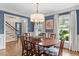 Dining room with hardwood floors, blue walls, and a view to the backyard at 8508 Zinfandel Pl, Raleigh, NC 27615