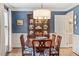 Dining room with blue walls, hardwood floors, and chandelier at 8508 Zinfandel Pl, Raleigh, NC 27615