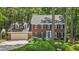 Charming two-story brick home featuring a two-car garage, dormer windows, and professionally landscaped front yard at 8508 Zinfandel Pl, Raleigh, NC 27615