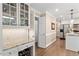 Bright kitchen featuring white cabinets, granite countertops, stainless steel appliances, and hardwood floors at 8508 Zinfandel Pl, Raleigh, NC 27615