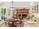 Inviting living room featuring a brick fireplace, built-in cabinets, and hardwood floors at 8508 Zinfandel Pl, Raleigh, NC 27615