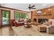 Cozy living room with a red brick fireplace, wood paneled walls and leather sofa at 8508 Zinfandel Pl, Raleigh, NC 27615