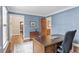 Office space featuring a wood desk, blue walls and ample natural light at 8508 Zinfandel Pl, Raleigh, NC 27615