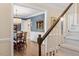 Staircase with carpeted steps, white rails, and views into dining and living spaces at 8508 Zinfandel Pl, Raleigh, NC 27615