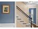 Stairway with white railings and wood-capped steps, leading to a room with natural light at 8508 Zinfandel Pl, Raleigh, NC 27615