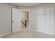 Bedroom with neutral carpet and walls, an open door and a closet with bi-fold doors at 8912 Erinsbrook Dr, Raleigh, NC 27617
