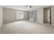 Large carpeted bedroom with built-in shelves and a view from the window at 8912 Erinsbrook Dr, Raleigh, NC 27617