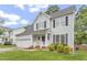 Beautifully landscaped two-story home with a well-manicured lawn, black shutters and an attached garage at 8912 Erinsbrook Dr, Raleigh, NC 27617