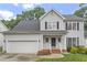 Charming two-story home with a well-manicured lawn, black shutters and a two car garage at 8912 Erinsbrook Dr, Raleigh, NC 27617