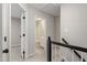 Upstairs hallway featuring an open doorway to bedroom and bathroom at 8912 Erinsbrook Dr, Raleigh, NC 27617