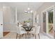 Eat-in kitchen featuring a table, view into the living room, and sliding glass doors to the deck at 8912 Erinsbrook Dr, Raleigh, NC 27617