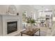 Cozy living room with a fireplace, modern decor, and an open view into the adjacent kitchen at 8912 Erinsbrook Dr, Raleigh, NC 27617