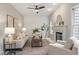 Inviting living room with a fireplace, large windows, neutral decor, and ample seating at 8912 Erinsbrook Dr, Raleigh, NC 27617