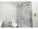 Modern bathroom with stylish white marble shower and toilet, featuring sleek glass doors and modern fixtures at 914 Forest Dr, Garner, NC 27529