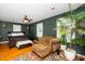 The primary bedroom has an accent wall with a king size bed, sitting area, and bright natural light at 914 Forest Dr, Garner, NC 27529