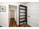 Hallway with shelving system and hardwood flooring, enhancing the home's organization and aesthetic appeal at 914 Forest Dr, Garner, NC 27529