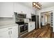 Modern kitchen with stainless steel appliances, white cabinets, and sleek countertops for efficient meal preparation at 914 Forest Dr, Garner, NC 27529